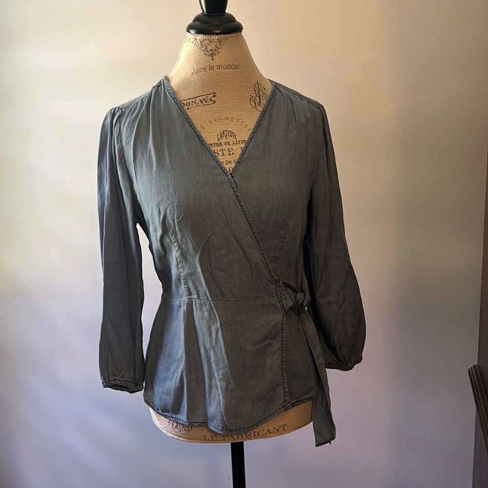 Women’s size small wrap front tencil blue top. Ties on the side. Fitted.